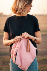 Outdoor atmospheric lifestyle photo of young beautiful  darkhaired woman   smiling and knitting...