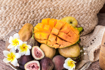 A plate of assorted fruits, sliced mango.