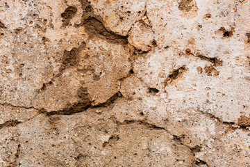 Texture of a concrete wall with cracks and scratches which can be used as a background