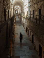 Haunted Prison Hallways with a Ghost Lurking in the Shadows
