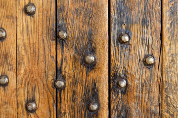 Old wooden boards with metal rivets.