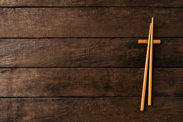 Bamboo chopstick on wooden background with copyspace