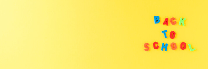 Back to school. Text on yellow background with copyspace. Banner