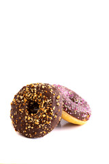 Chocolate glazed donut with nuts  and with sprinkle on white modern background. Copy space