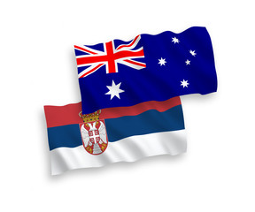 National vector fabric wave flags of Australia and Serbia isolated on white background. 1 to 2 proportion.
