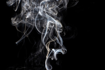 Fototapeta premium Abstract white smoke swirls on black background
