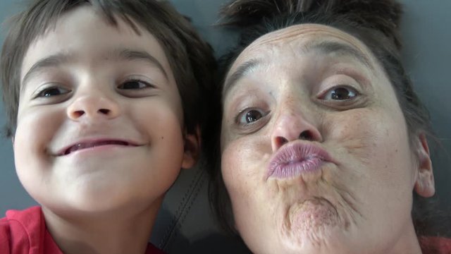 4K Selfie Close up Comic mother and child declare love on camera and send funny kisses