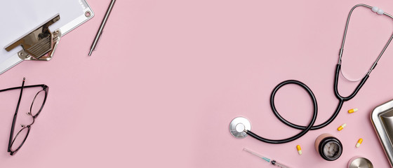 Creative flatlay of doctor medical equipment pink table with stethoscope, medical documents,...