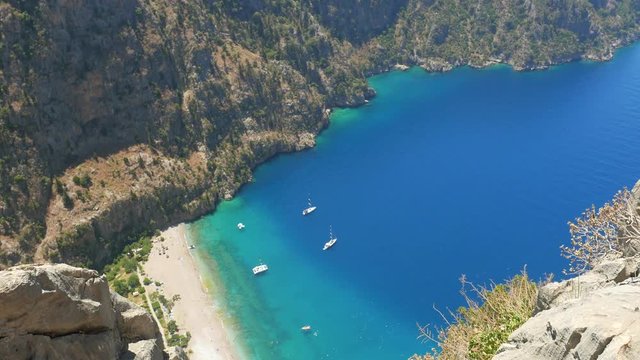 Woman traveller enjoying beautiful view of The Butterfly Valley from the top of the mountain