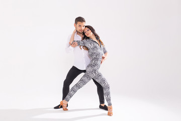 Social dance concept - Active happy adults dancing bachata or salsa together over white background...