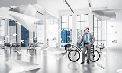 Young man wearing business suit with bike