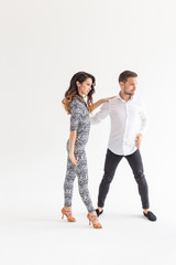 Obraz premium Salsa, kizomba and bachata dancers on white background with copy space. Social dance concept