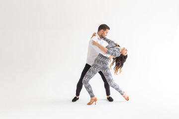 Young love couple dancing social danse kizomba or bachata over white background with copy space