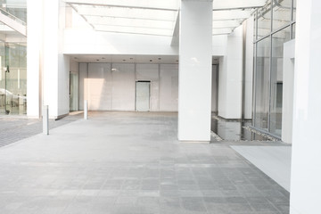 Obraz na płótnie Canvas Morning Business building background office lobby hall interior empty indoor room with blurry light from glass wall window..