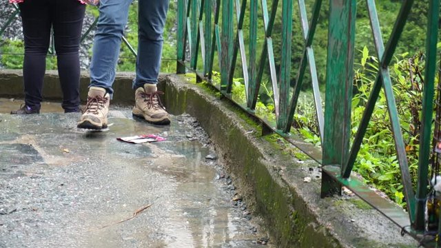 Slow motion shot of indian women climbing down stairs with trekking and sport shoes on a mountain trek with lush green backgrounds
