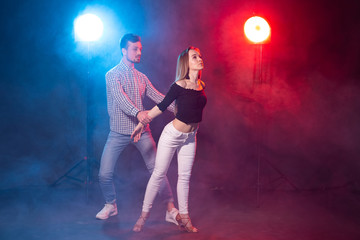 Fototapeta premium Social dance, kizomba, salsa, semba or zouk concept - a young couple dancing bachata and salsa at the disco