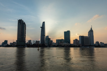skyline view from the river. Vietnamese City with modern building, high rise Relection on water of  Asiatic Metropolis of  Saigon know also as Ho Chi Minh city, South Vietnam.