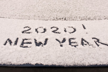 The inscription 2020 on the snow. The inscription on the car. The concept of a New year.