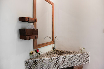 Interior of bathroom with sink basin faucet and mirror.