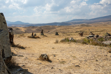Fototapeta na wymiar Carahunge, also called Zorats Karer, Karahunj, Qarahunj and Carenish. Landscape. 