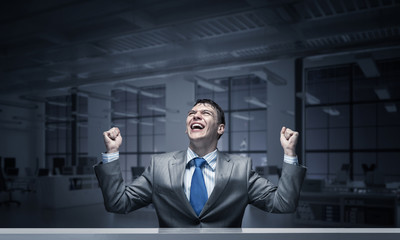 Happy excited businessman celebrating victory