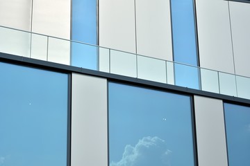 Facade fragment of a modern office building. Exterior of glass wall with abstract texture.