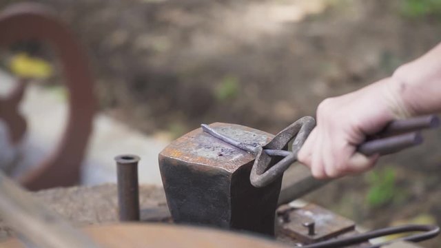 Smith forges nails in slow motion