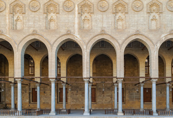 Fototapeta na wymiar Arched corridor surrounding the courtyard of public ancient mosque of Sultan Al Moaayad, Old Cairo, Egypt