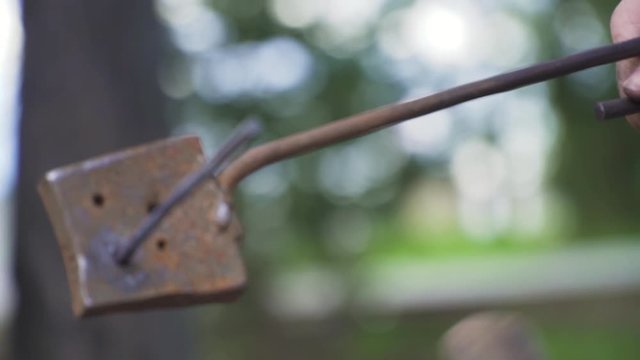 Smith forges nails in slow motion