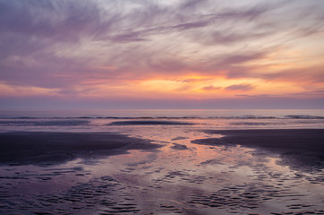 Sunrise over sea and beach at low tide