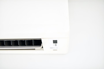 Moder air condition unit on a white wall inside the living room.