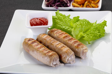 Grilled sausages served mushrooms and cabbage