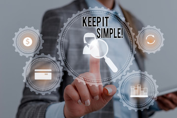 Writing note showing Keep It Simple. Business concept for ask something easy understand not go into too much detail Woman wear formal work suit presenting presentation using smart device