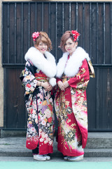 Japanese girls posing for the pictures of the Coming of Age Day. In Japan, people celebrate their 20s of a year as becoming adults wearing Japanese tradition dress.