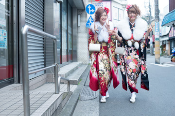 Japanese girls posing for the pictures of the Coming of Age Day. In Japan, people celebrate their 20s of a year as becoming adults wearing Japanese tradition dress.