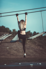 Attractive young sporty woman is working outside. Cross fit training. Muscular woman. Young, fit...