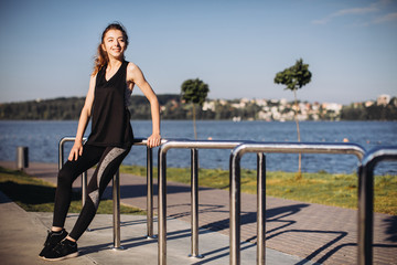 Sporty girl posing by the lake