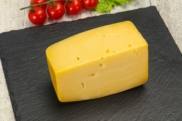 Hard yellow tasty cheese brick