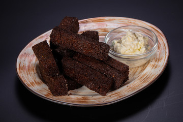 Black crouton with garlic sauce