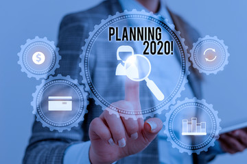 Writing note showing Planning 2020. Business concept for process of making plans for something next year Woman wear formal work suit presenting presentation using smart device