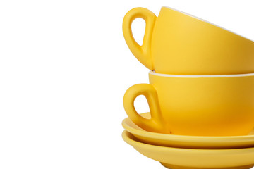 Set of yellow cups and saucers isolated on white