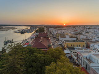 Aerial sunset cityscape of Olhao downtown, Algarve fishing village view of ancient neighbourhoods cubist architecture and market. Portugal.