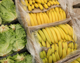 full boxes of green fresh lettuce and yellow bananas