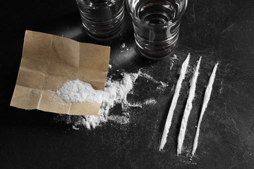 close up pile of cocaine in paper and vodka on black background, cocain on black background