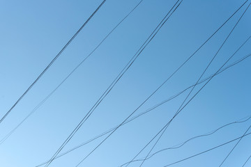 Abstract Lines of electric Cables Wires with blue Sky in City
