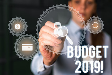 Word writing text Budget 2019. Business photo showcasing estimate of income and expenditure for current year Woman wear formal work suit presenting presentation using smart device