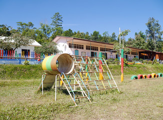 The playground is located in the middle of the school football field.