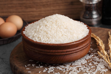thai white jasmine rice in wooden bowl in kitchen with a blank space for a text, thai agriculture concept