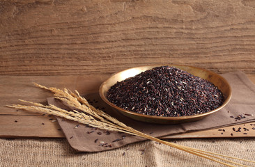 riceberry rice in golden tray on table with a blank space for a text, riceberry rice in kitchen background