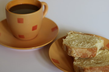 cup of coffee and cake on table, close up, white background
